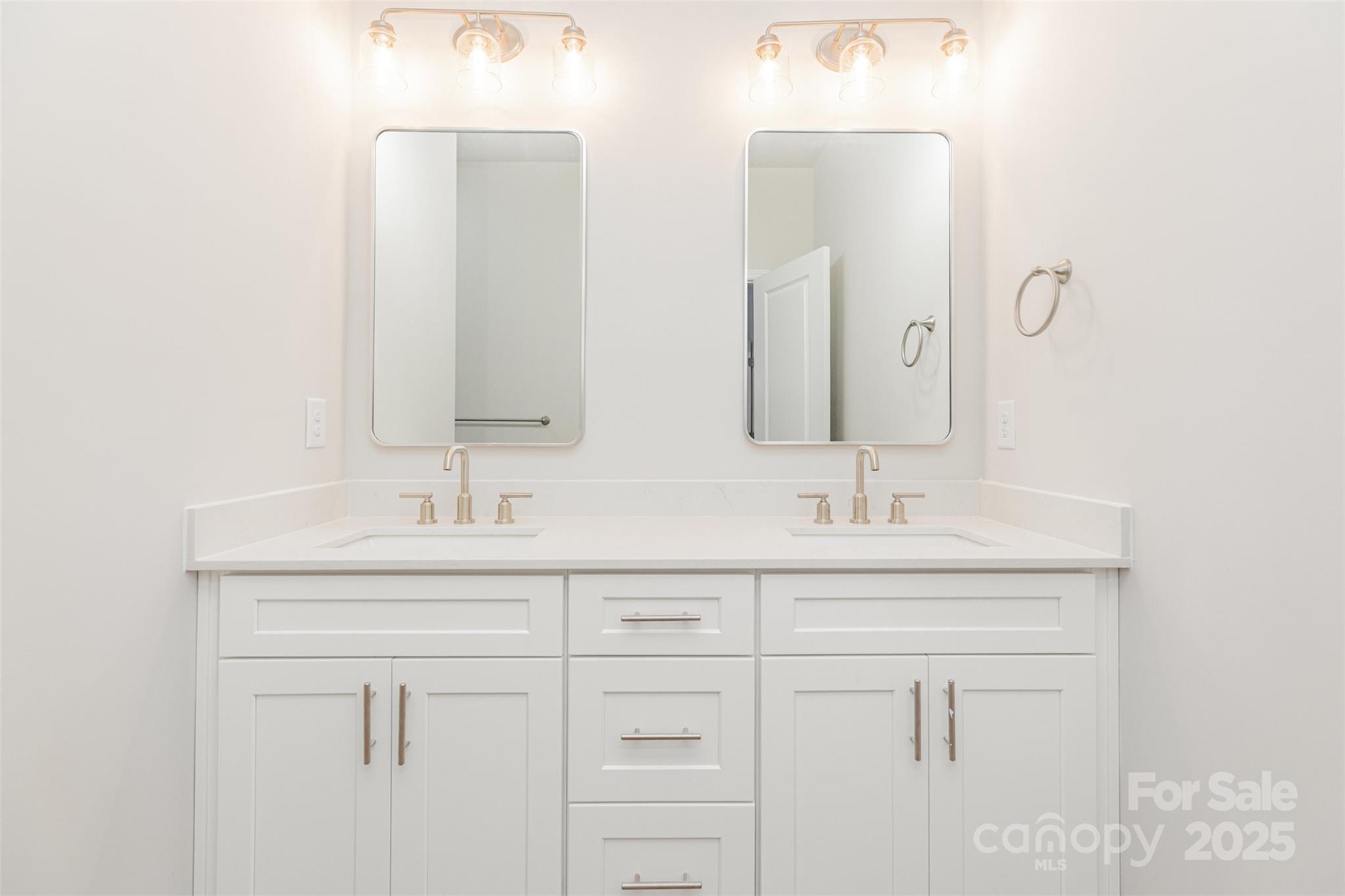 7304 Boswell Road Charlotte, NC 28215 - Photo 20 of 30 a bathroom with double sink a mirror and a vanity