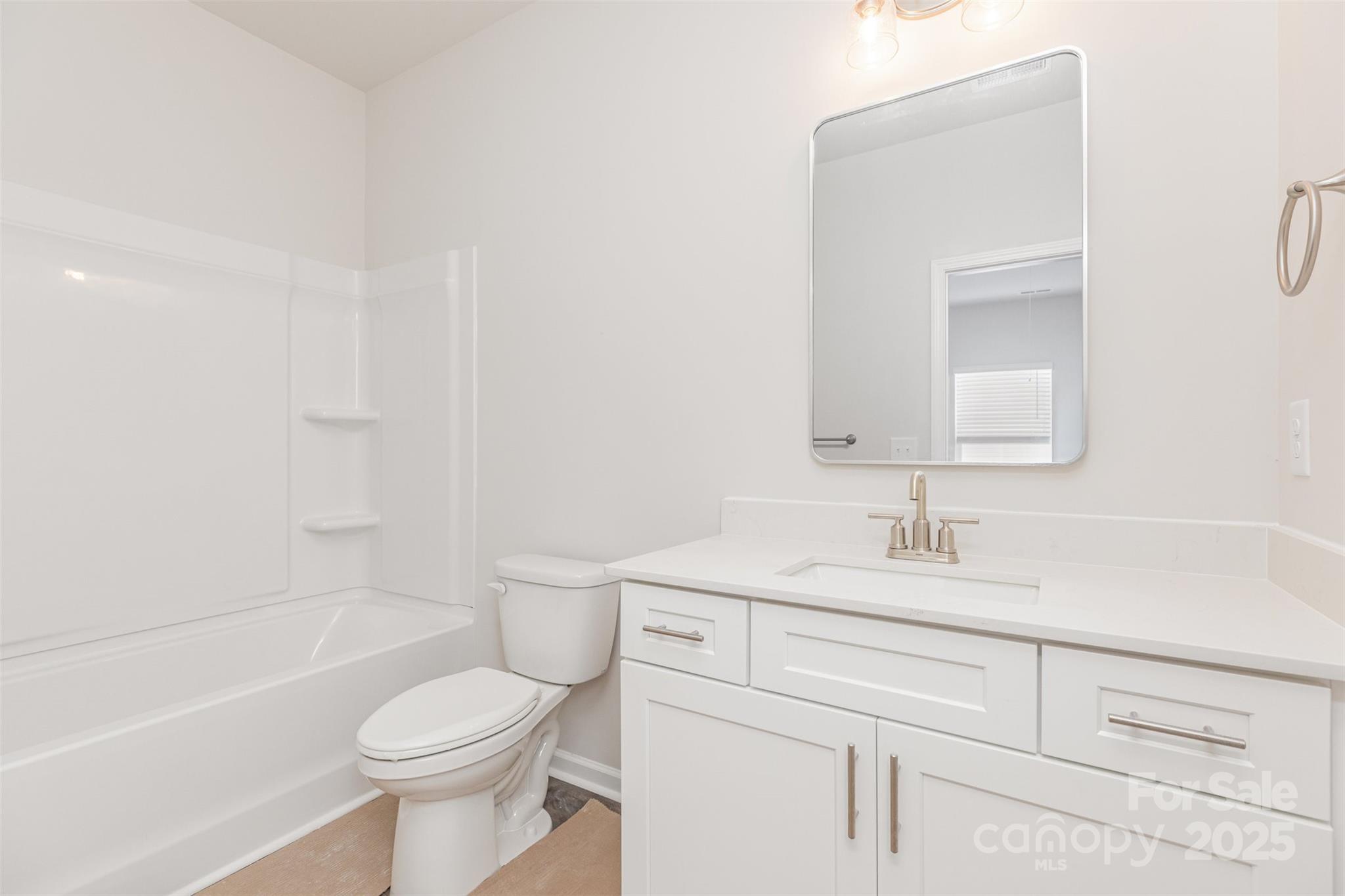 7304 Boswell Road Charlotte, NC 28215 - Photo 26 of 30 a bathroom with a sink a toilet and shower