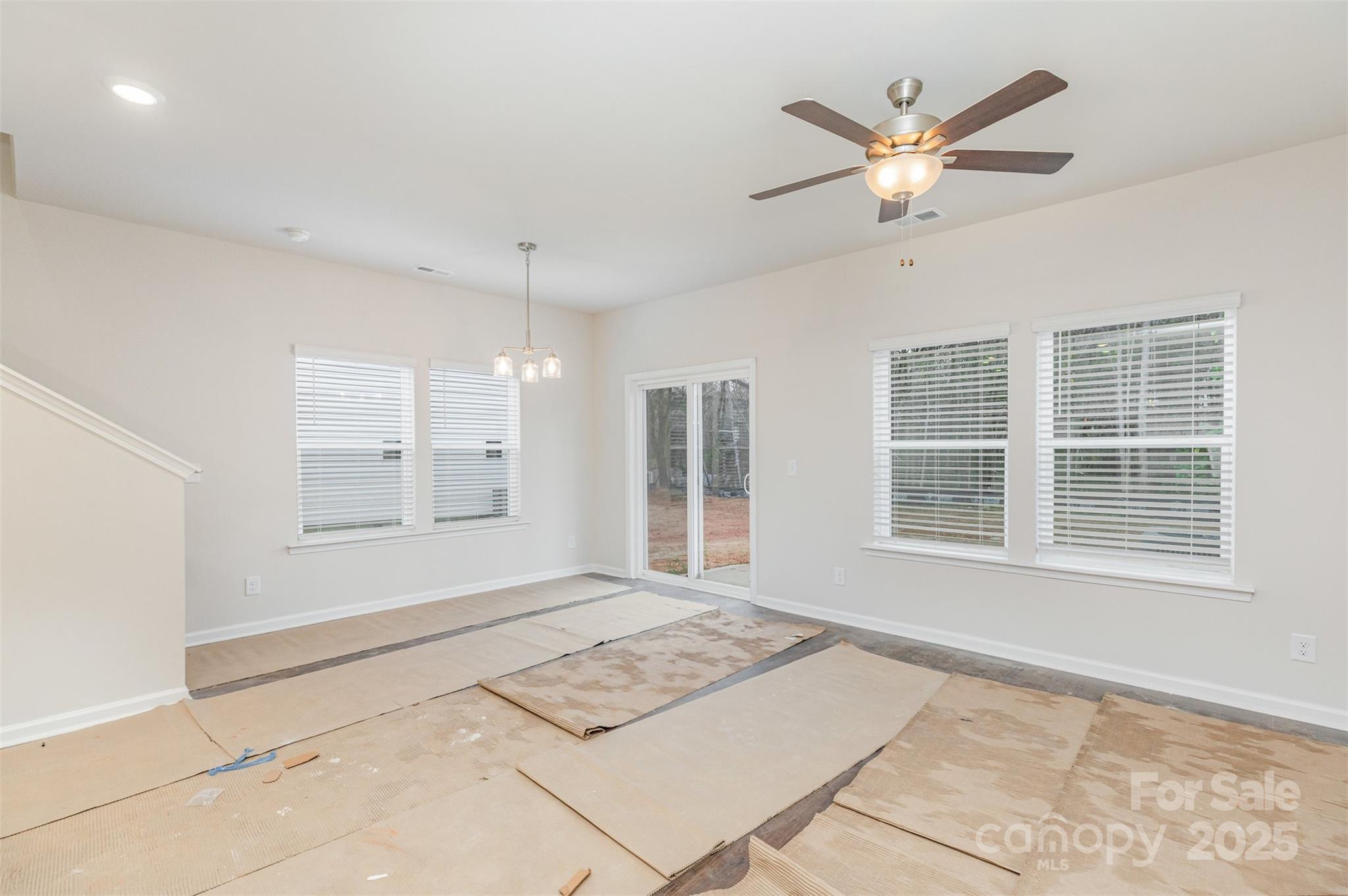 7304 Boswell Road Charlotte, NC 28215 - Photo 7 of 30 a view of a livingroom with a window and a ceiling fan