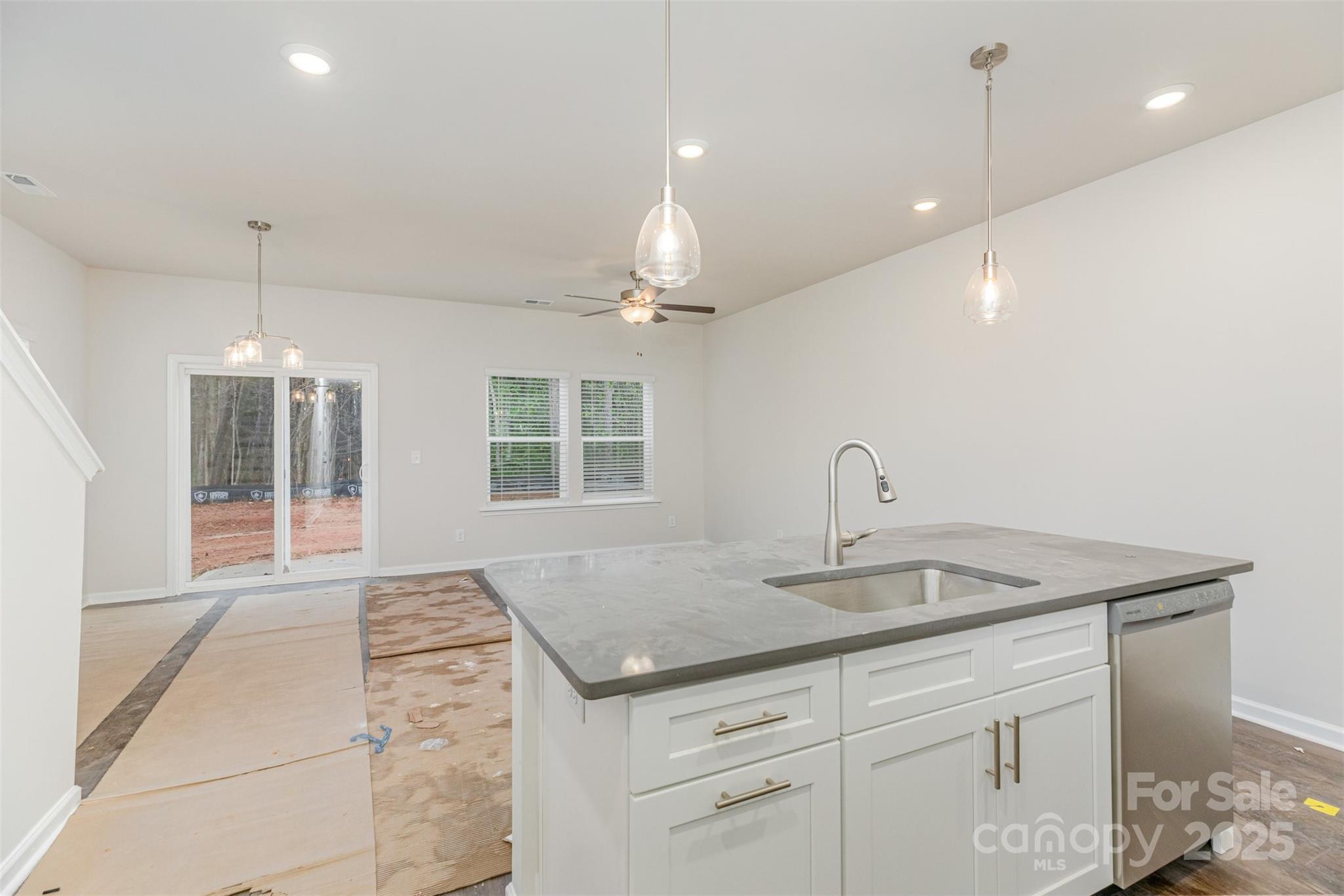 7304 Boswell Road Charlotte, NC 28215 - Photo 9 of 30 a kitchen with a sink chandelier and wooden floor
