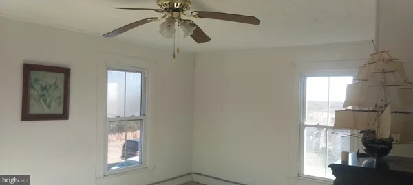 a living room with furniture a flat screen tv and a window