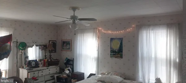 a view of livingroom with hardwood floor and a ceiling fan