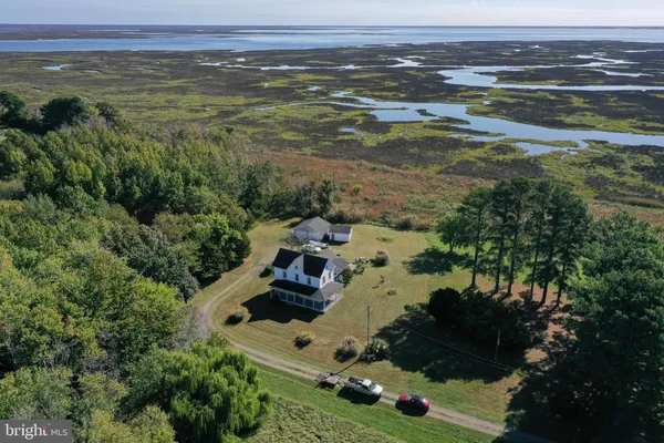 an aerial view of a houses with a yard