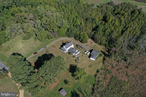 an aerial view of a house with a yard
