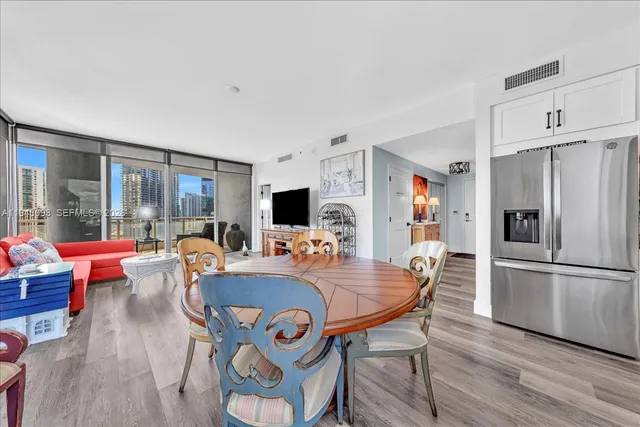a dining room with furniture and wooden floor