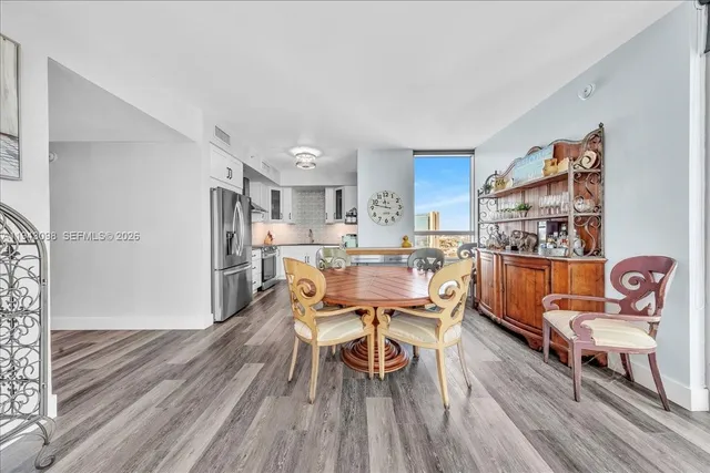 a view of a livingroom with wooden floor and a flat screen tv