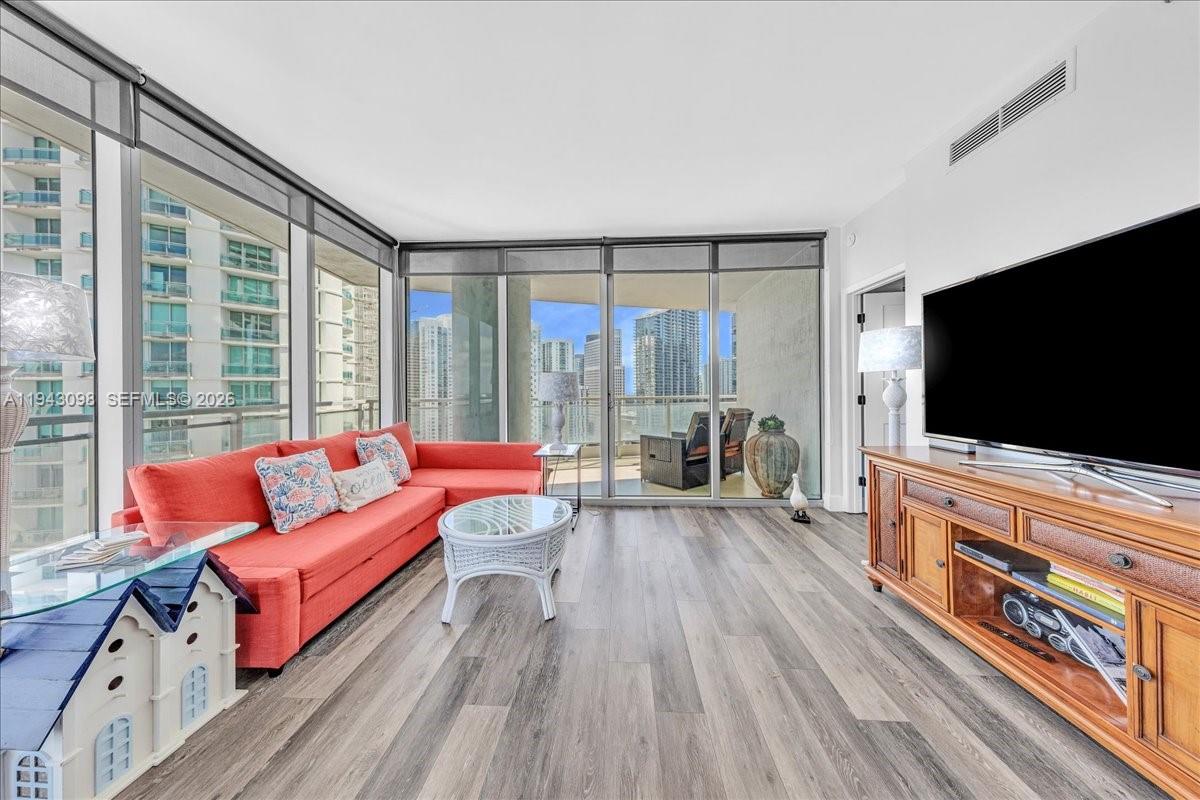 90 Southwest 3rd Street, Unit 2604 Miami, FL 33130 - Photo 17 of 59 a living room with furniture and a flat screen tv