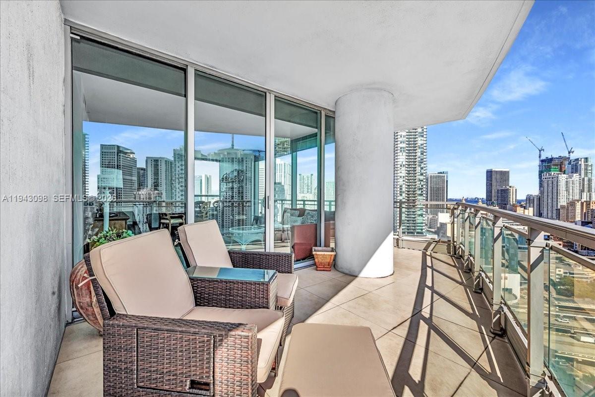 90 Southwest 3rd Street, Unit 2604 Miami, FL 33130 - Photo 21 of 59 a living room with furniture and a floor to ceiling window