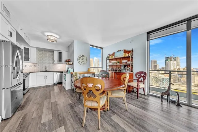 a view of a dining room with furniture and wooden floor