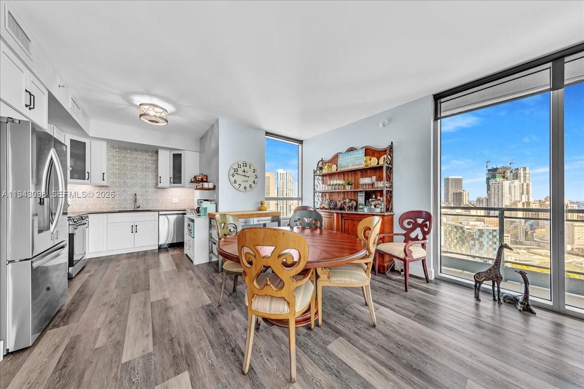 90 Southwest 3rd Street, Unit 2604 Miami, FL 33130 - Photo 3 of 59 a view of a dining room with furniture and wooden floor
