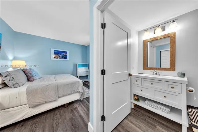 a bedroom with furniture and wooden floor