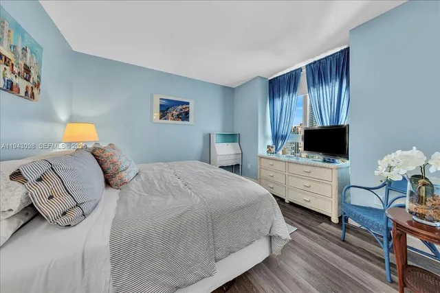 a bedroom with a bed and a flat screen tv