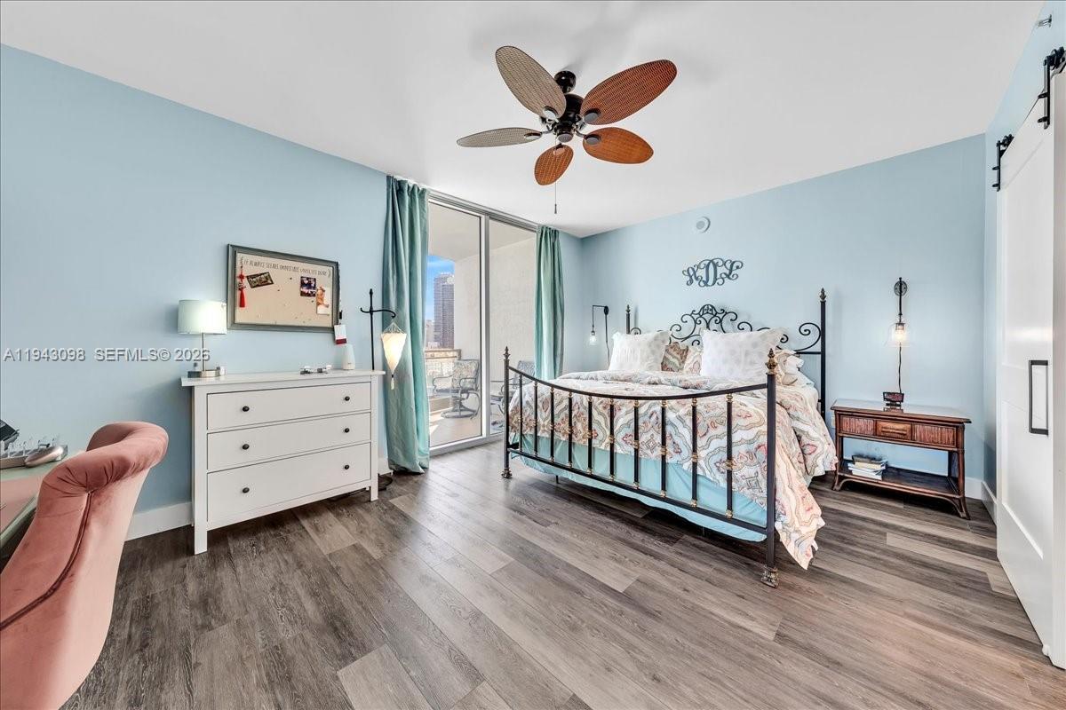 90 Southwest 3rd Street, Unit 2604 Miami, FL 33130 - Photo 35 of 59 a bedroom with furniture and wooden floor