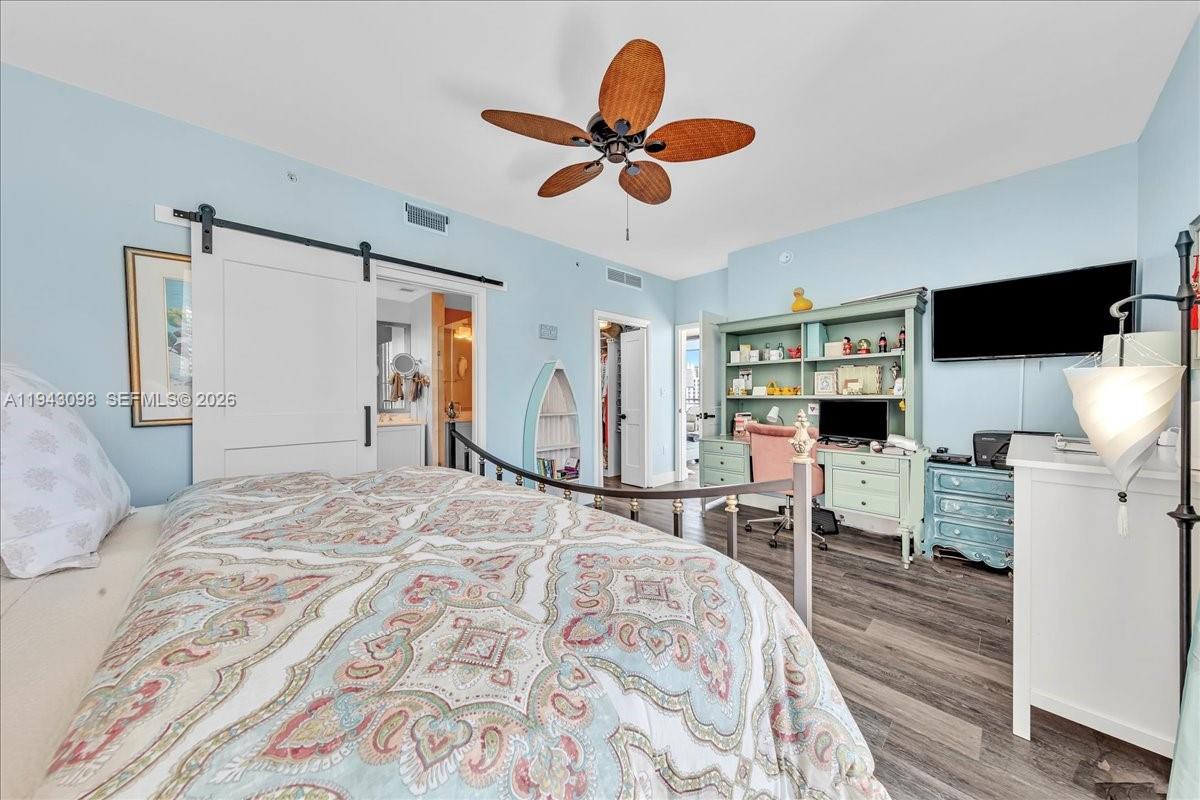 90 Southwest 3rd Street, Unit 2604 Miami, FL 33130 - Photo 37 of 59 a bedroom with a bed and a flat screen tv