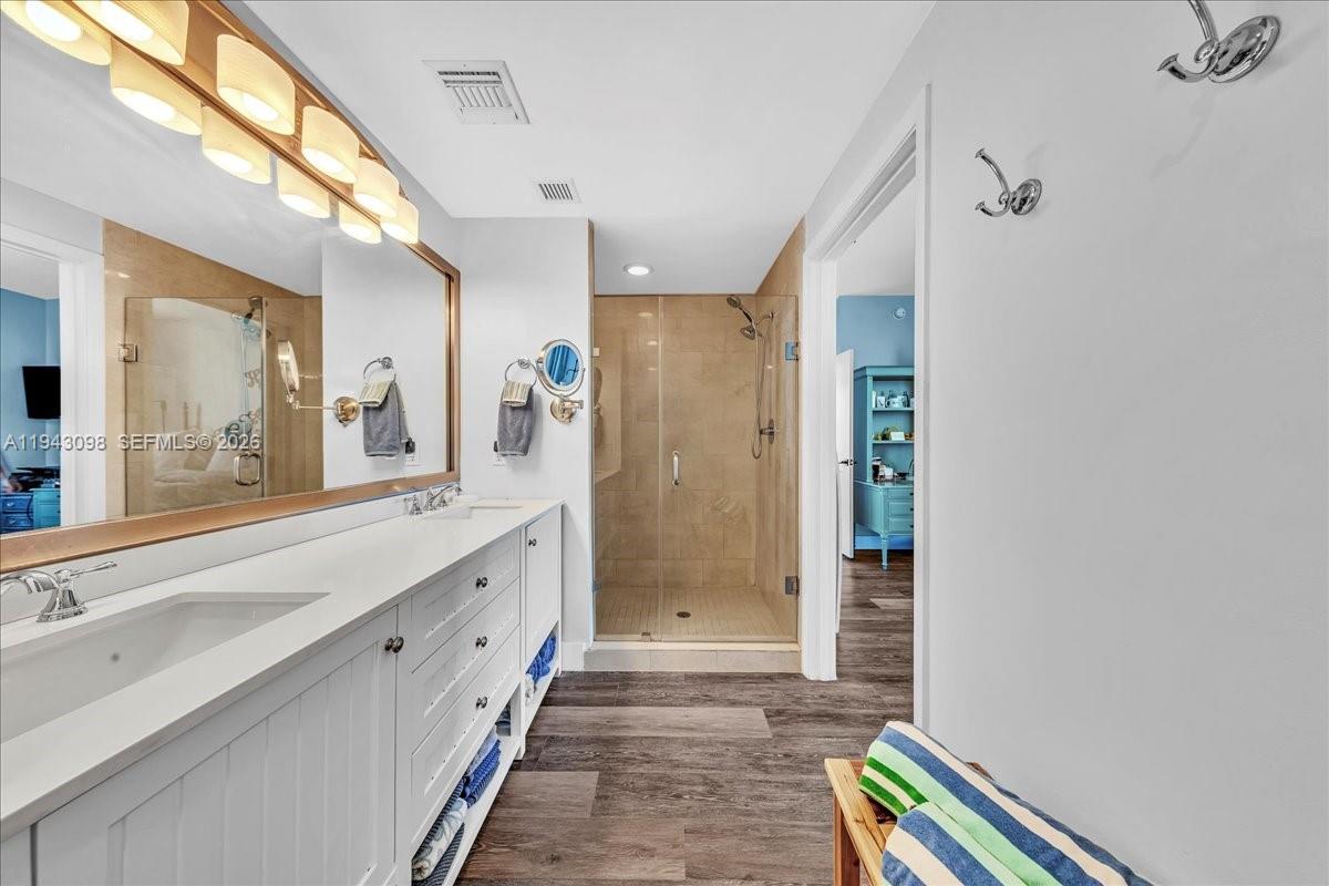 90 Southwest 3rd Street, Unit 2604 Miami, FL 33130 - Photo 40 of 59 a spacious bathroom with a double vanity sink a large mirror a bathtub and shower