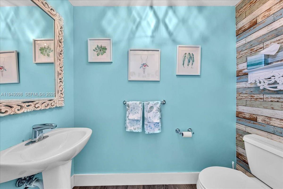 90 Southwest 3rd Street, Unit 2604 Miami, FL 33130 - Photo 43 of 59 a bathroom with a toilet a sink and mirror