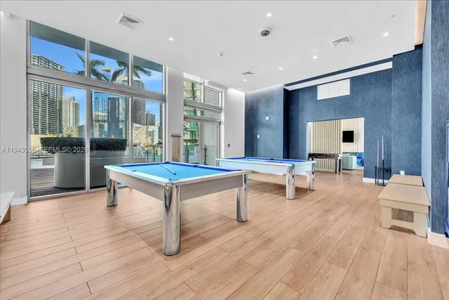 a kitchen with stainless steel appliances granite countertop a sink a stove and a dining table view