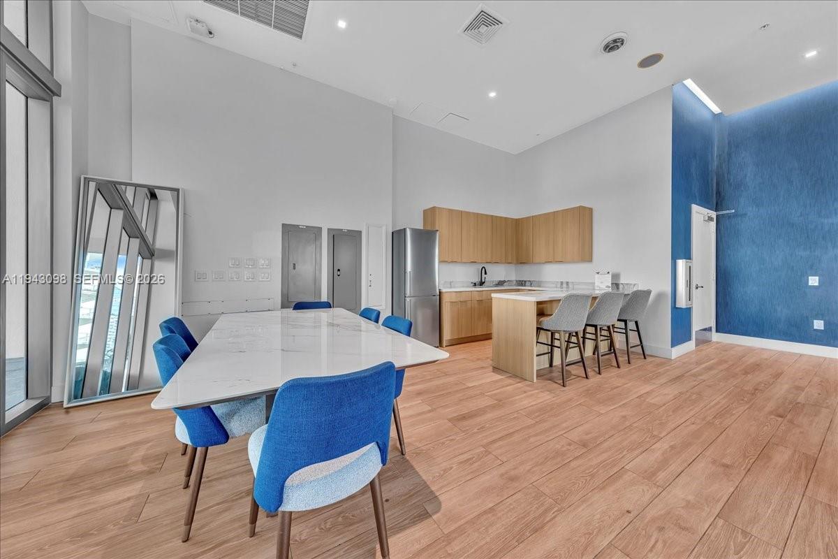 90 Southwest 3rd Street, Unit 2604 Miami, FL 33130 - Photo 48 of 59 a view of a dining room with furniture and wooden floor