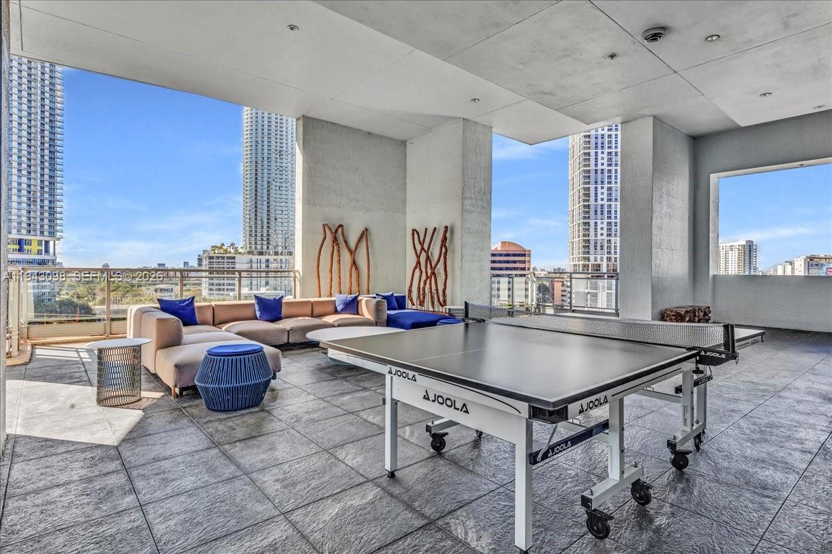 90 Southwest 3rd Street, Unit 2604 Miami, FL 33130 - Photo 54 of 59 a kitchen with stainless steel appliances granite countertop a sink a stove and a dining table view