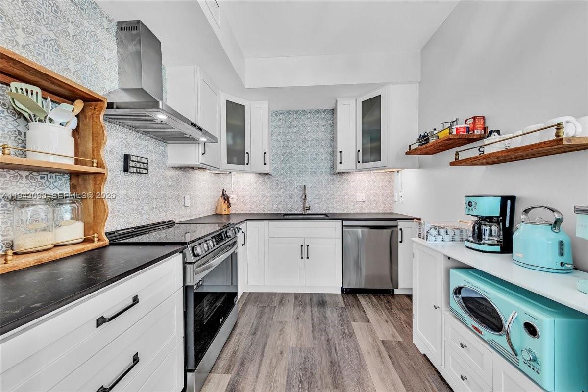 90 Southwest 3rd Street, Unit 2604 Miami, FL 33130 - Photo 9 of 59 a kitchen with granite countertop a sink dishwasher stove and cabinets