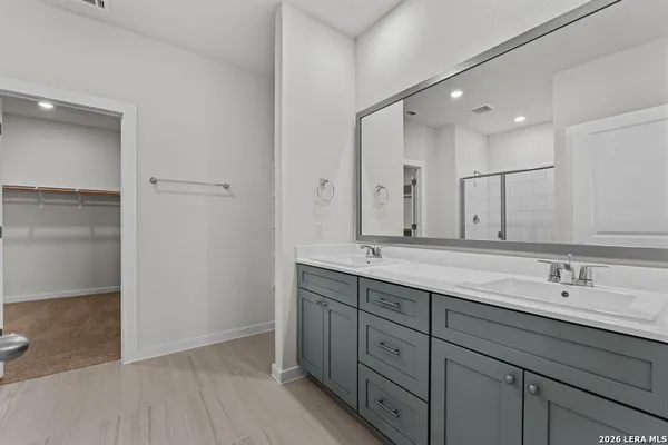 a bathroom with a double vanity sink and a mirror