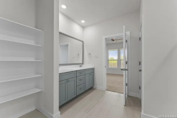 a bathroom with a granite countertop sink mirror and toilet