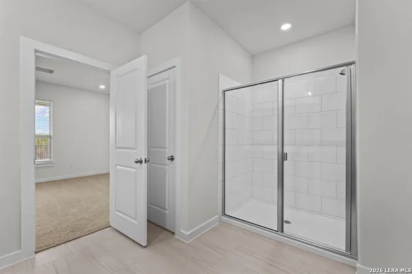 a bathroom with a shower and a glass door