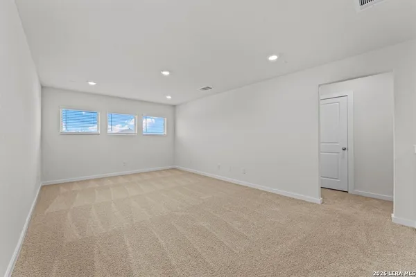 a view of an empty room with windows