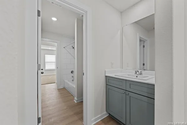 a bathroom with a double vanity sink mirror and toilet