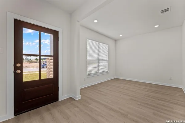 an empty room with windows and closet