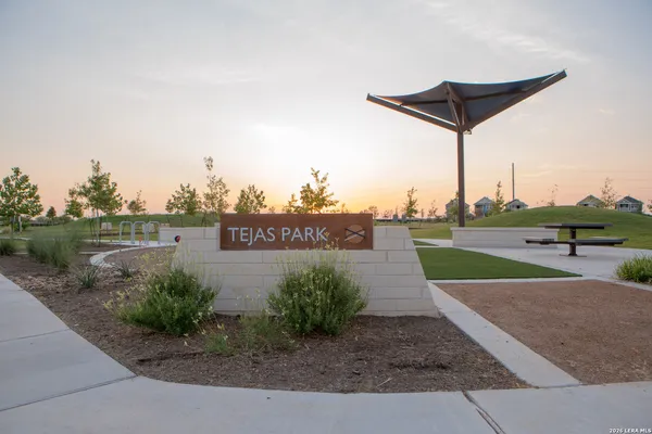 a view of a street with a yard and a fence
