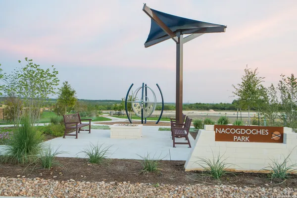 a view of swimming pool with a patio and a garden