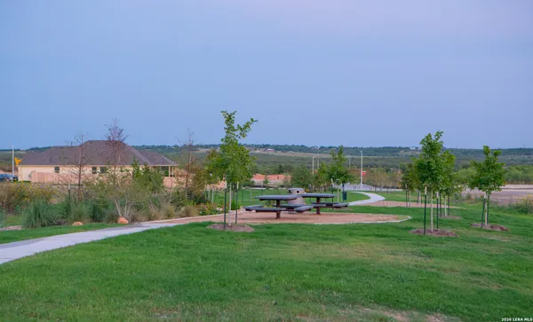 a view of a big yard with a table and chairs