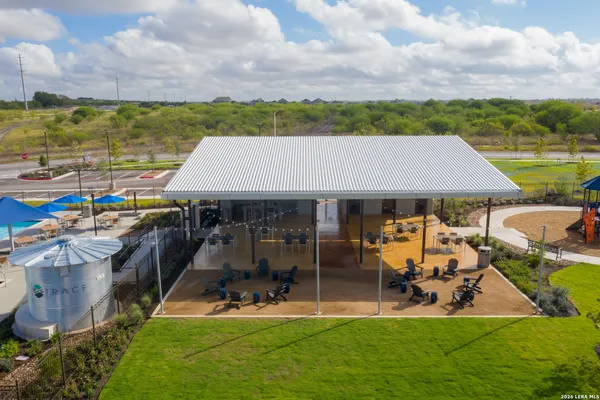 an aerial view of a house with a garden and lake view