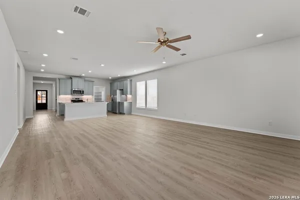 a view of a kitchen with a sink a refrigerator and window