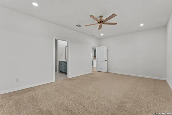 an empty room with closet and windows