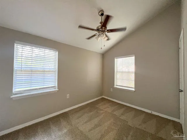 a view of a room with a ceiling fan and a window