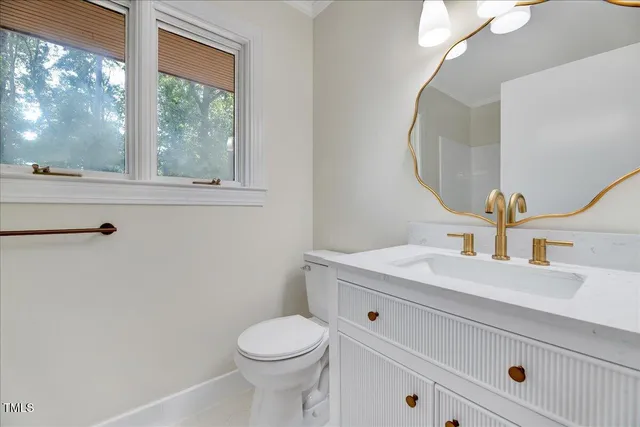 a bathroom with a sink vanity and a mirror