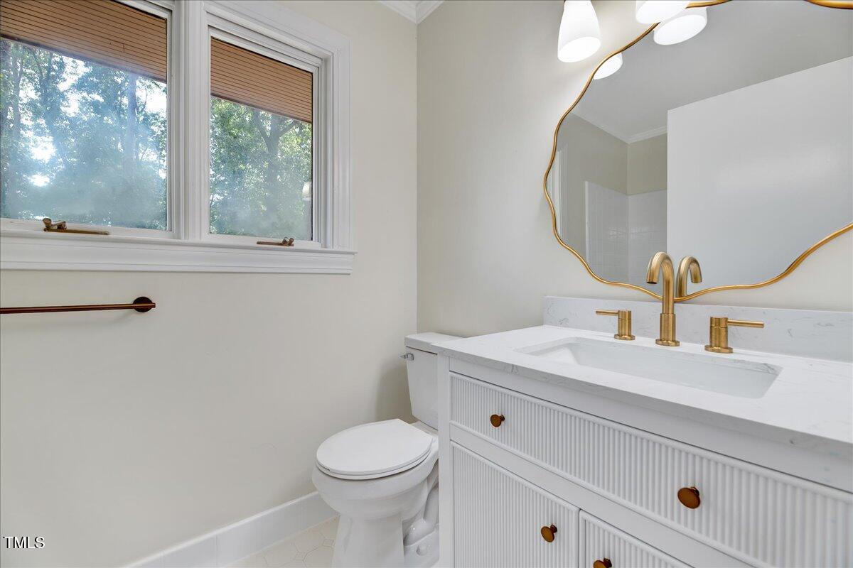 2585 Cabin Branch Road Kinston, NC 28504 - Photo 10 of 42 a bathroom with a granite countertop toilet sink mirror and window