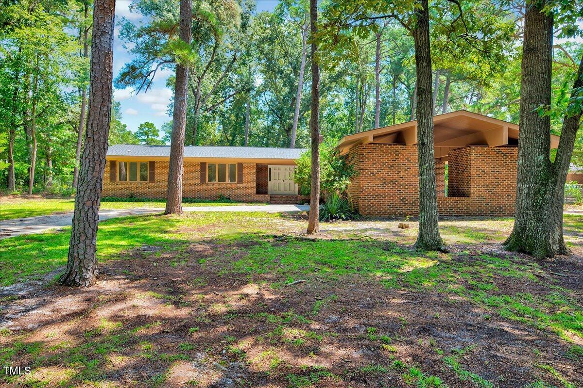 2585 Cabin Branch Road Kinston, NC 28504 - Photo 11 of 42 a view of a house with backyard and a tree