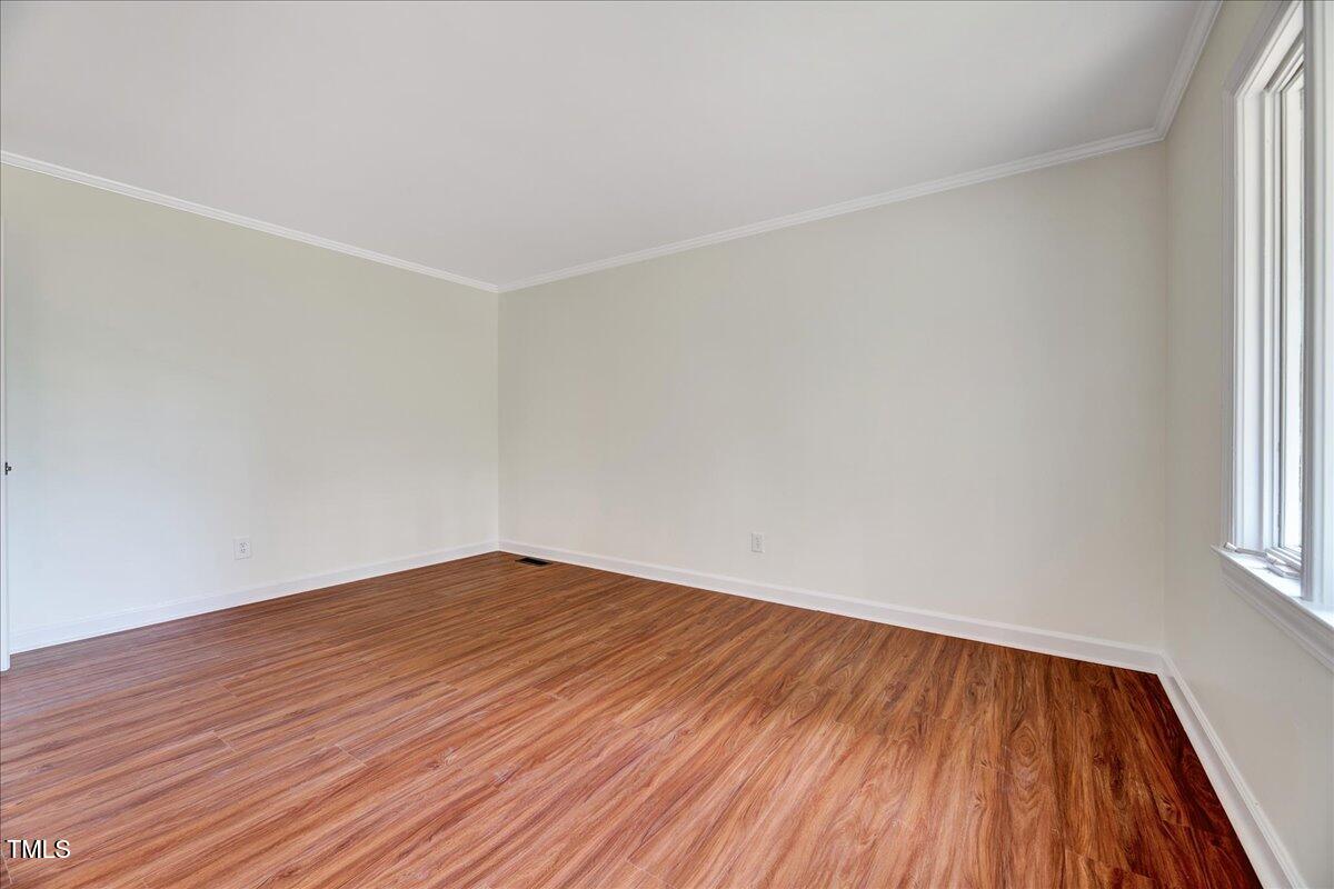 2585 Cabin Branch Road Kinston, NC 28504 - Photo 17 of 42 an empty room with wooden floor and windows