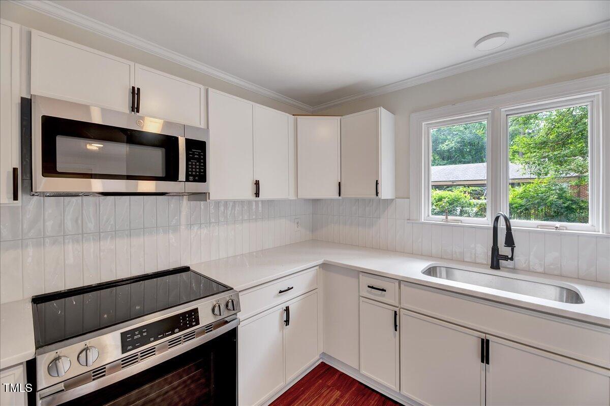 2585 Cabin Branch Road Kinston, NC 28504 - Photo 18 of 42 a kitchen with a sink stove and microwave