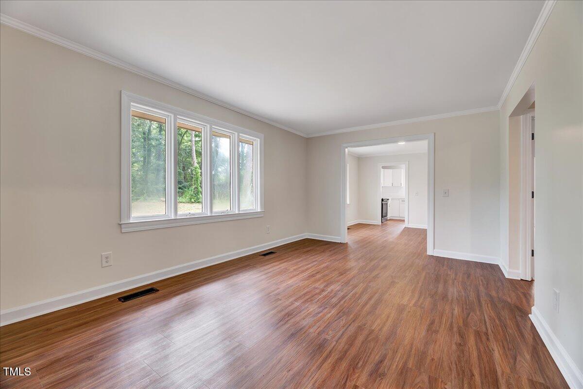 2585 Cabin Branch Road Kinston, NC 28504 - Photo 20 of 42 a view of an empty room with wooden floor and a window
