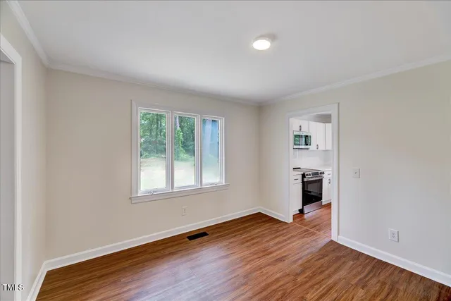 wooden floor in an empty room with a window