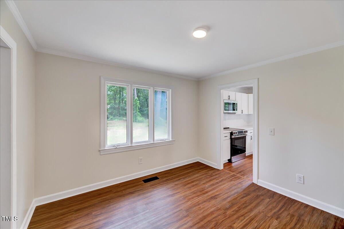 2585 Cabin Branch Road Kinston, NC 28504 - Photo 22 of 42 an empty room with wooden floor and windows