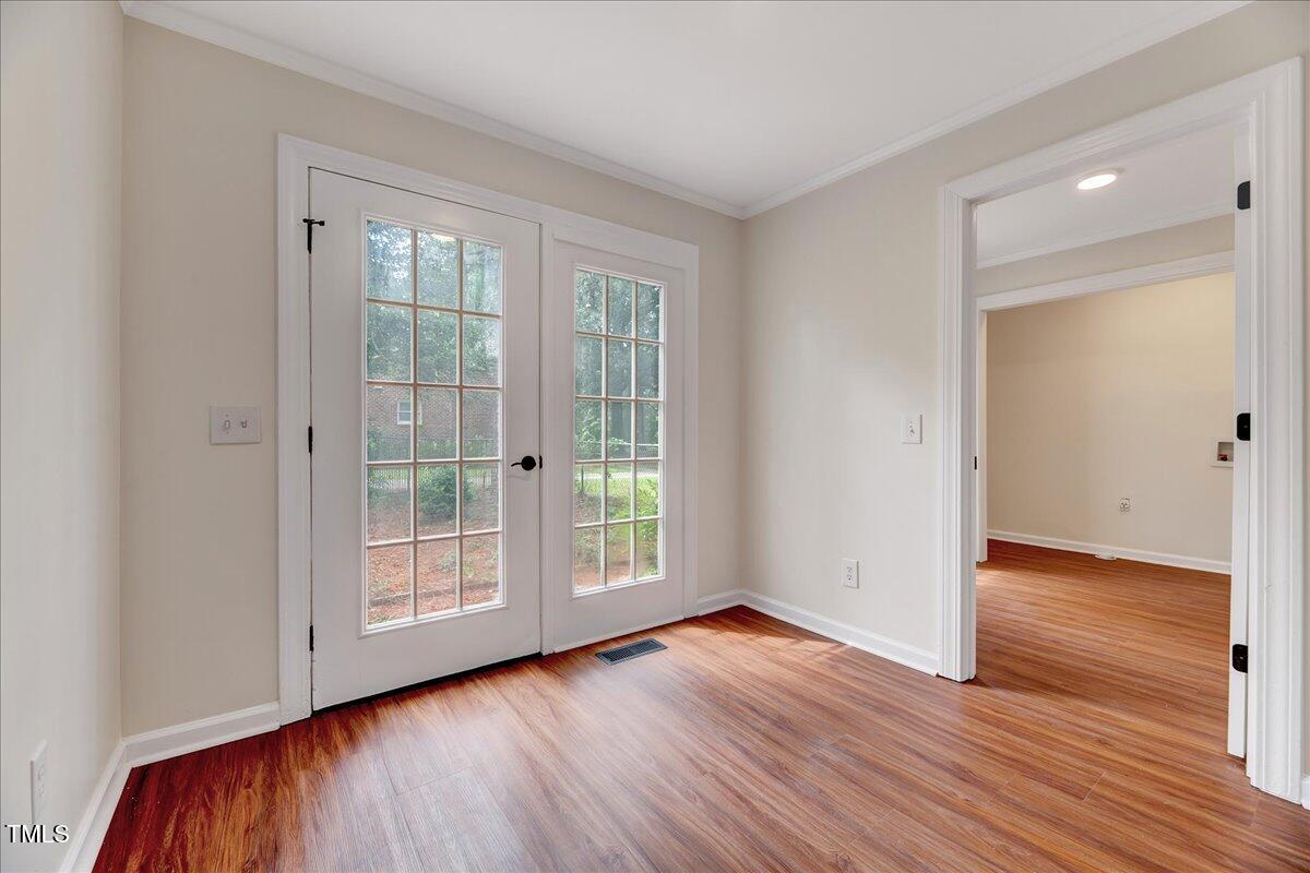 2585 Cabin Branch Road Kinston, NC 28504 - Photo 23 of 42 an empty room with wooden floor and windows