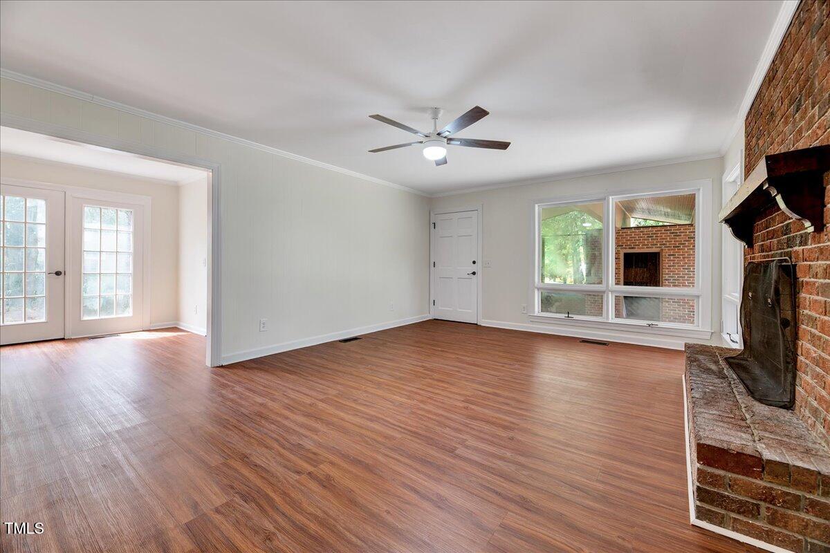 2585 Cabin Branch Road Kinston, NC 28504 - Photo 25 of 42 a view of a livingroom with wooden floor and a ceiling fan