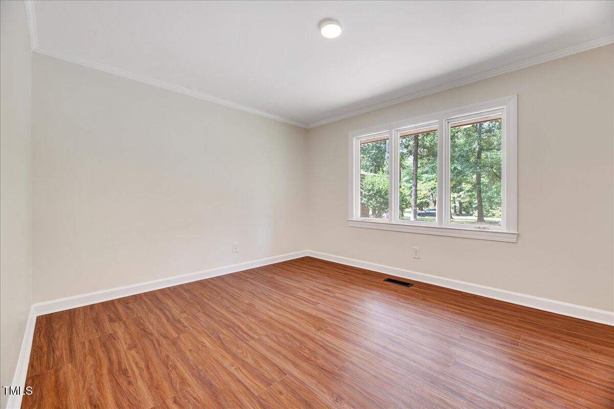 2585 Cabin Branch Road Kinston, NC 28504 - Photo 27 of 42 an empty room with wooden floor and windows