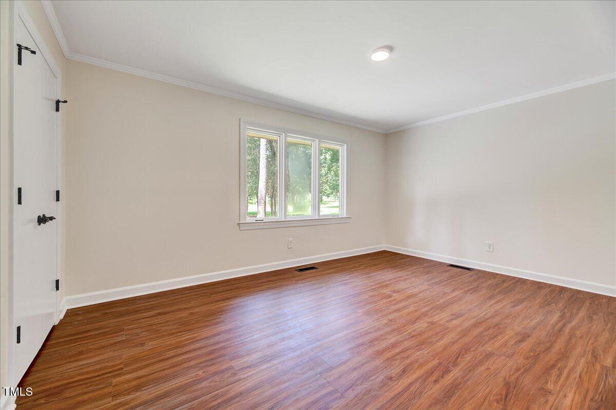 2585 Cabin Branch Road Kinston, NC 28504 - Photo 29 of 42 a view of an empty room with wooden floor and a window