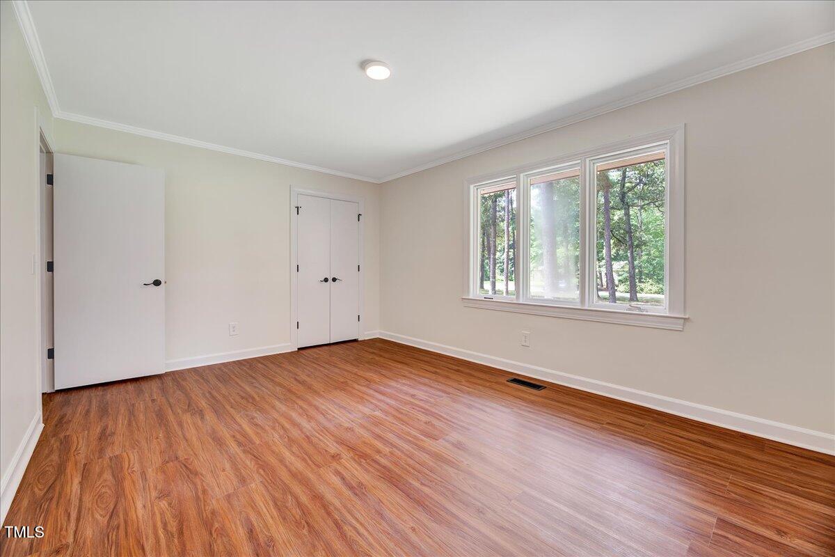 2585 Cabin Branch Road Kinston, NC 28504 - Photo 30 of 42 a view of an empty room with wooden floor and a window